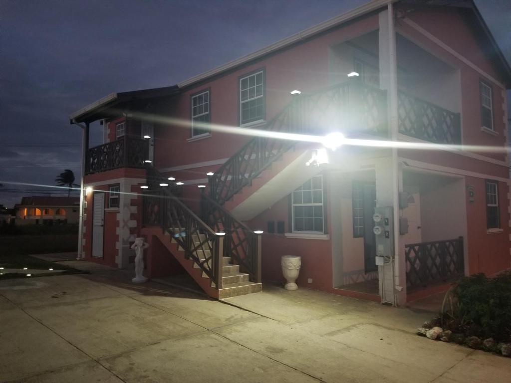 a house with a light on the side of it at Breezy Apts in Saint Philip