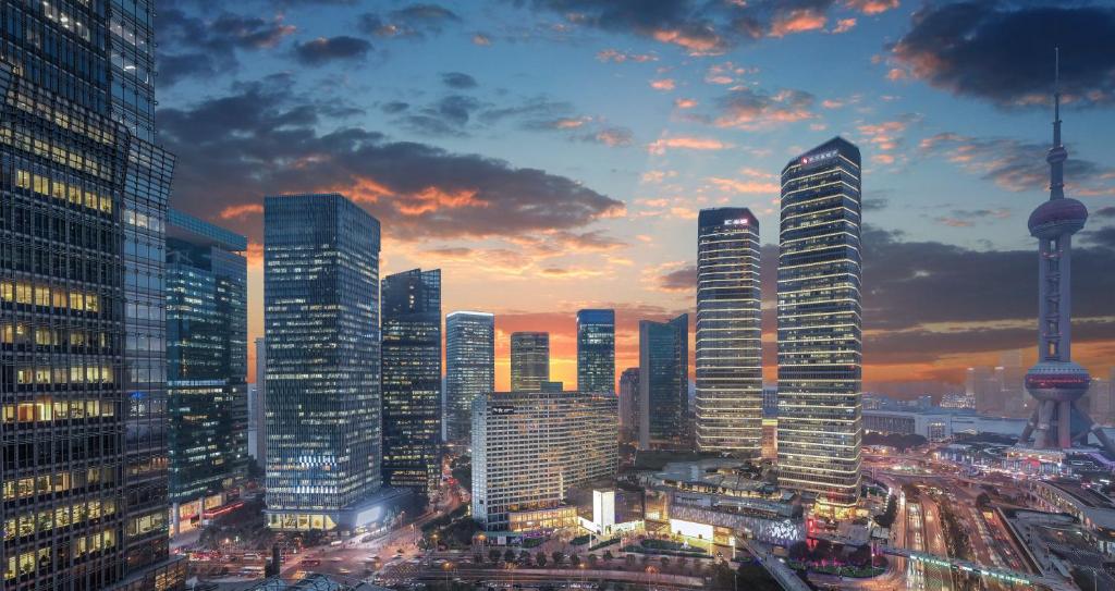 a city skyline at dusk with tall buildings at IFC Residence in Shanghai