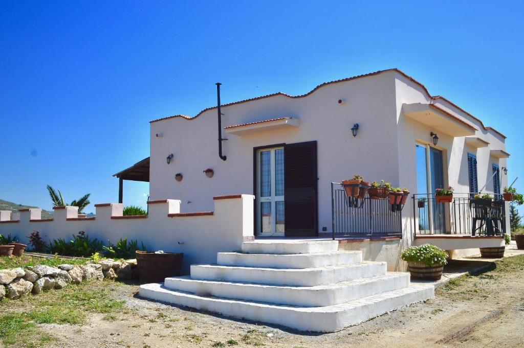 a white house with stairs in front of it at Villa Chiara in Montallegro