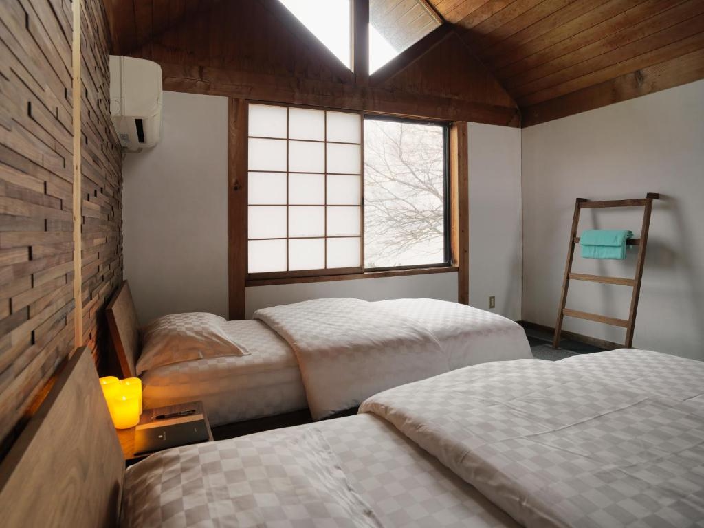 Postel nebo postele na pokoji v ubytování Shiraishi Island International Villa