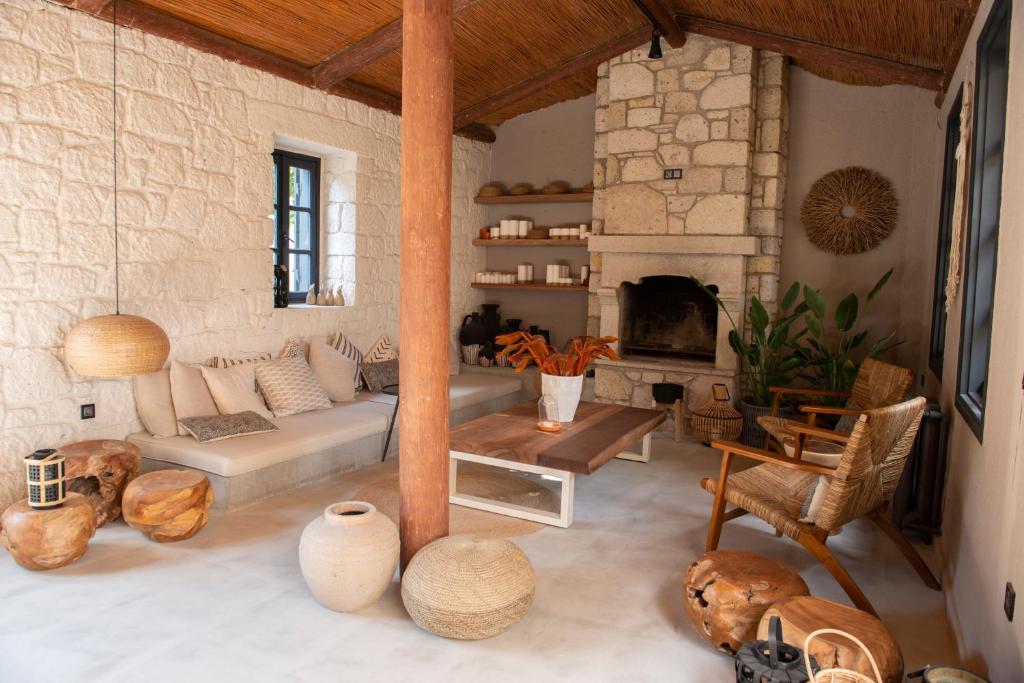 a living room with a couch and a fireplace at GAIA ALAÇATI in Alaçatı