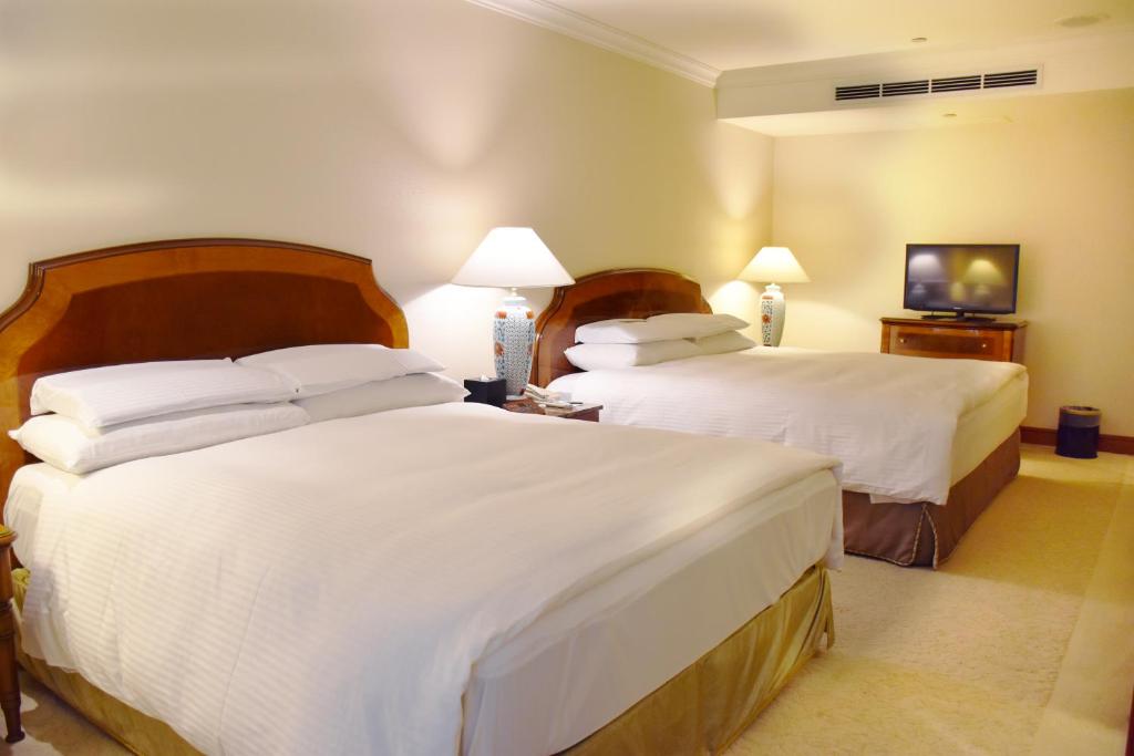 Postel nebo postele na pokoji v ubytování Evergreen Laurel Hotel Taipei