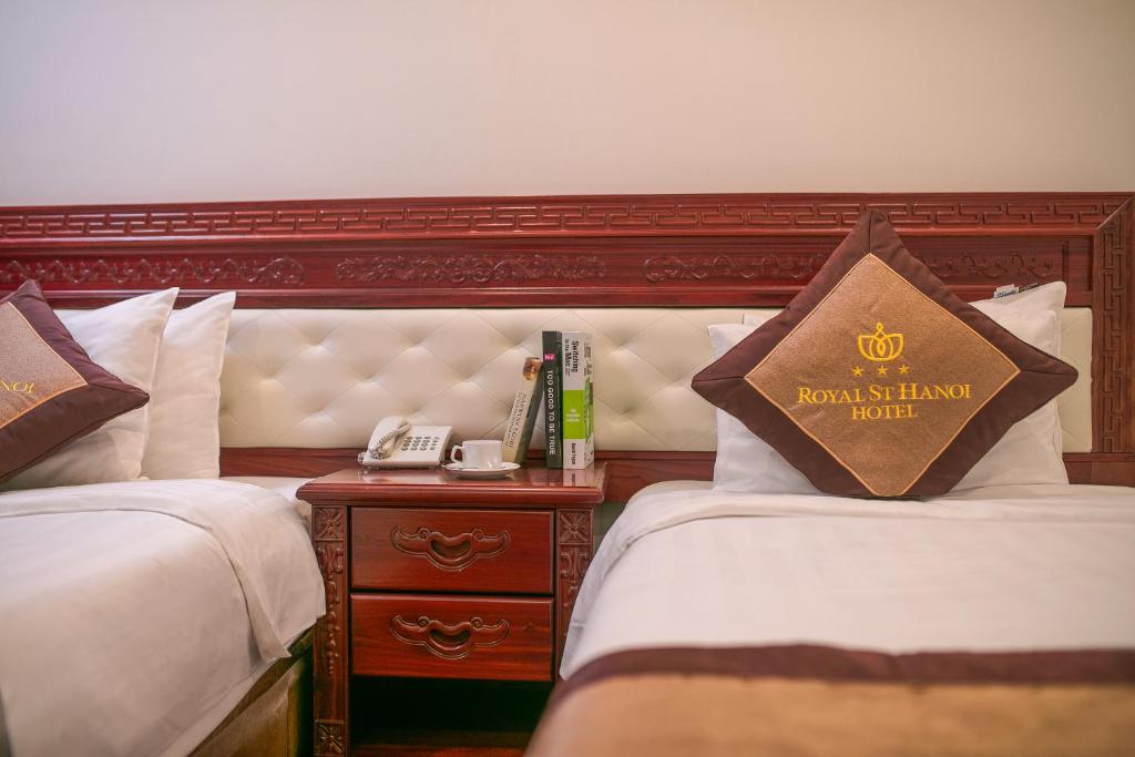 Postel nebo postele na pokoji v ubytování Royal St Hanoi Hotel