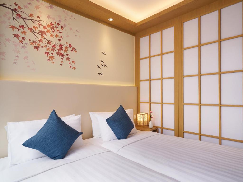 Postel nebo postele na pokoji v ubytování Hotel COZi Resort Tuen Mun