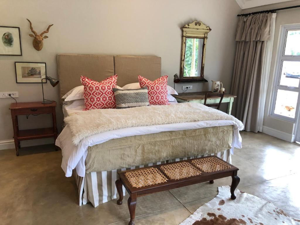 a bedroom with a large bed with pillows on it at Lavender Trout Guest Farm in Nottingham Road