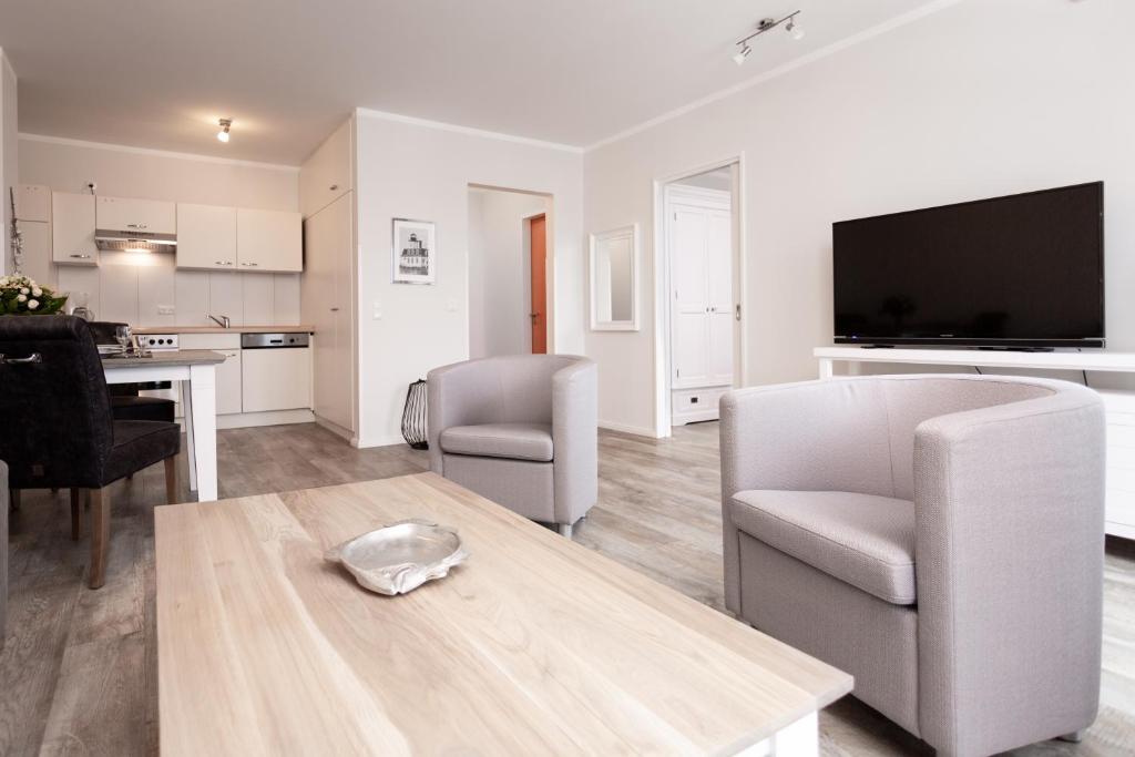 TV a/nebo společenská místnost v ubytování strandnahe FeWos mit Balkon, Residenz Bel Vital - Kategorie B