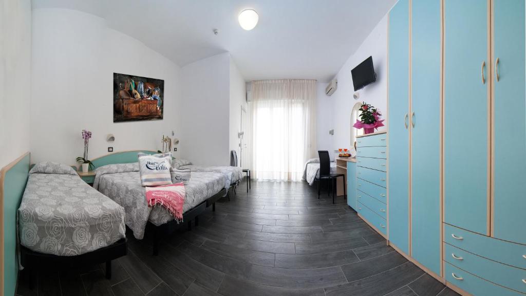 Postel nebo postele na pokoji v ubytování Hotel Letizia