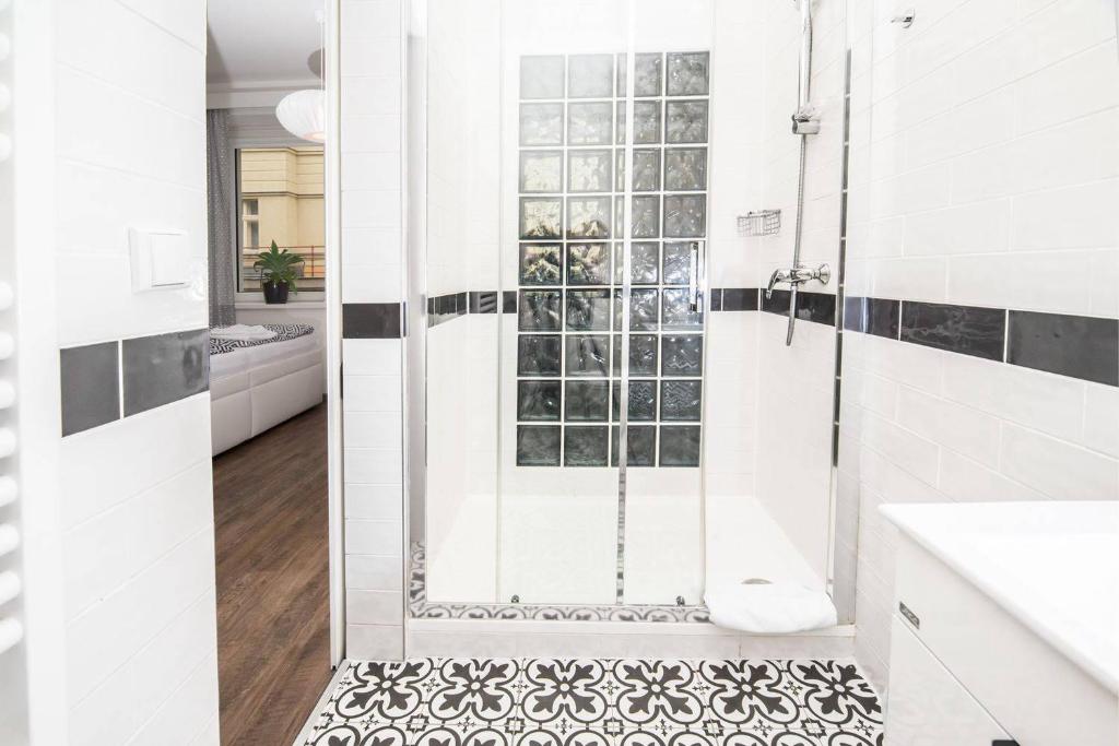 a white bathroom with a shower with a glass door at Hotel Na Baste in Jablonec nad Nisou