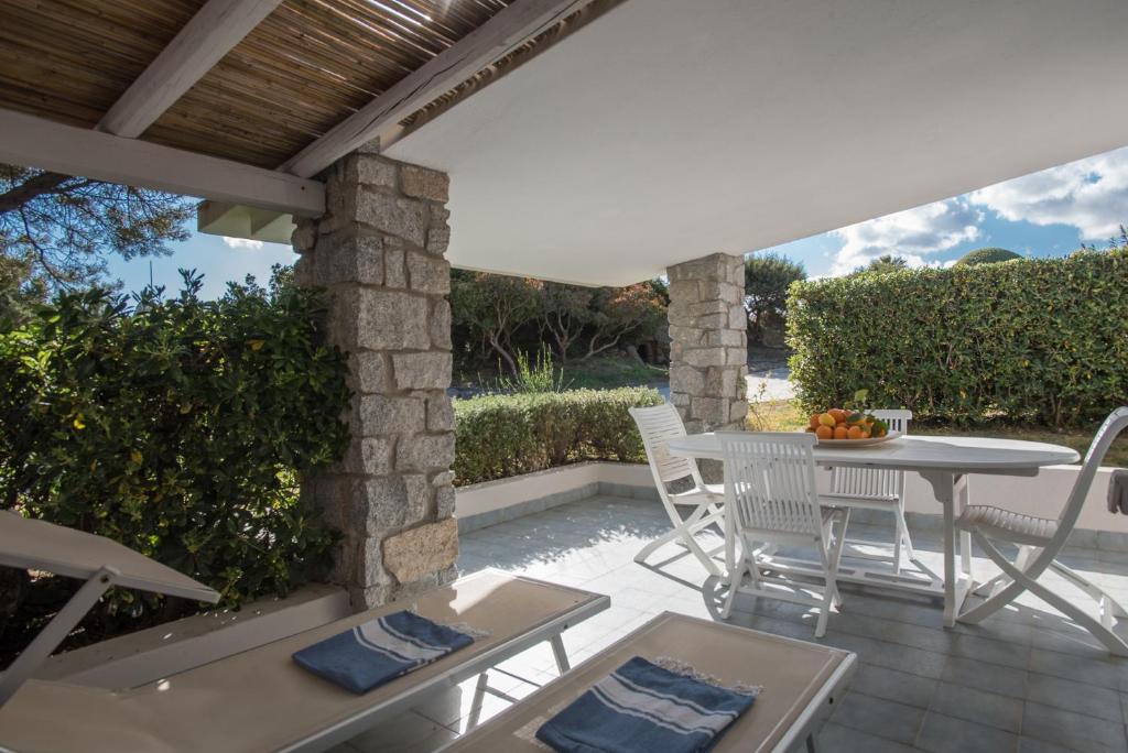 a patio with a table and chairs on a patio at Sul Mare Sardegna Villa Eudora in Villasimius