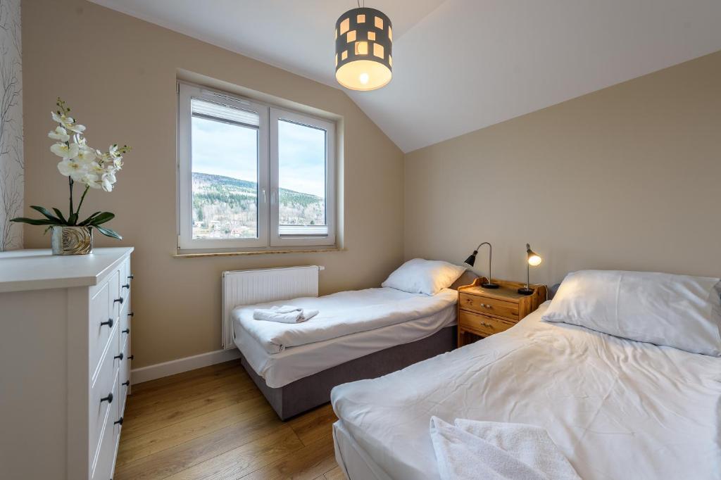 Łóżko lub łóżka w pokoju w obiekcie Apartament Widokowy - 5D Apartamenty