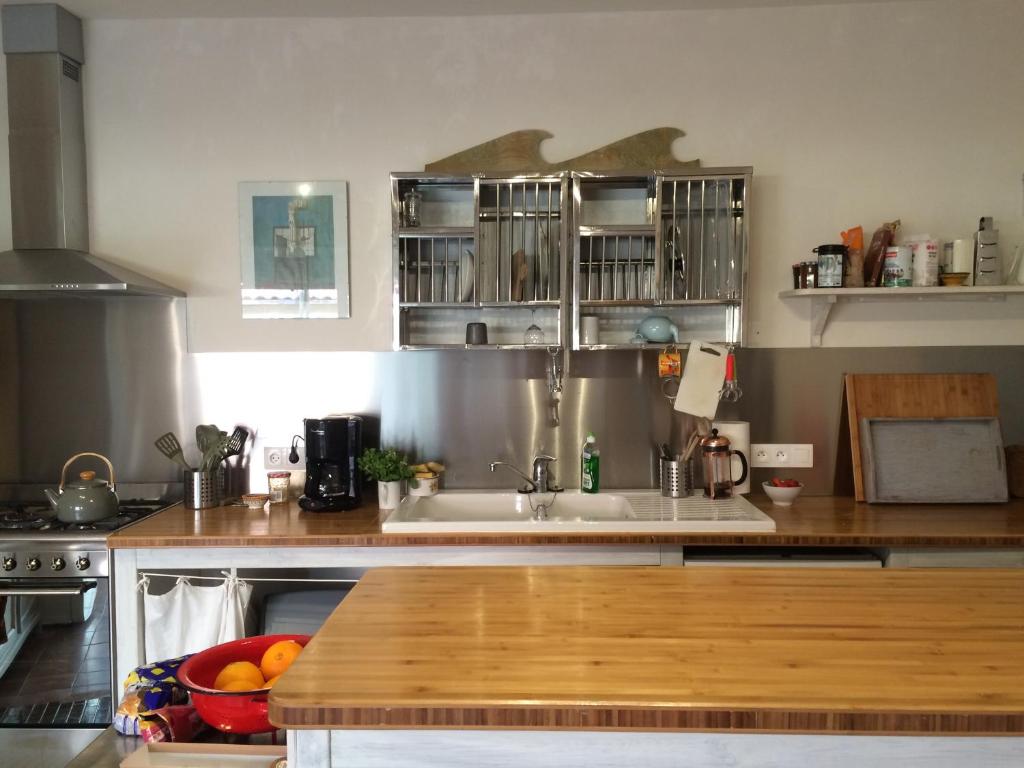 a kitchen with a wooden counter top and a sink at La villa tamaris maison à partager in Vieux-Boucau-les-Bains