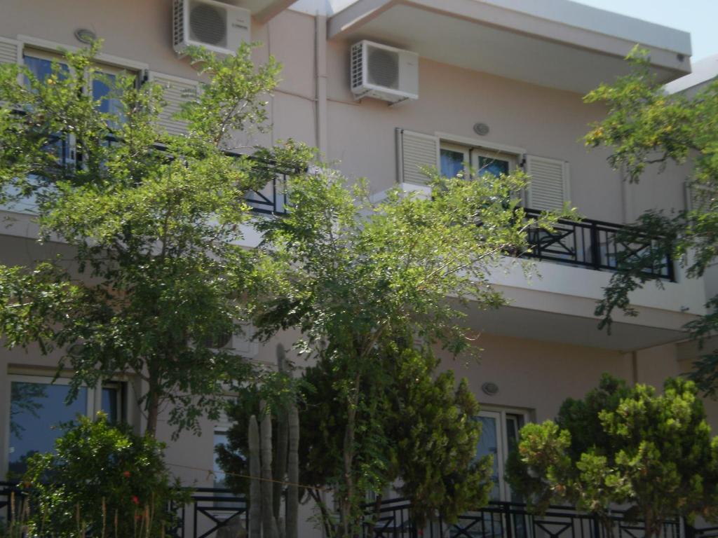 an apartment building with trees in front of it at Amazon Studios in Agia Marina Nea Kydonias