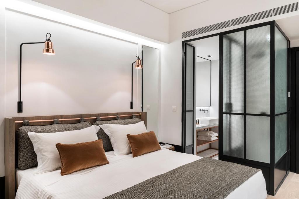 Postel nebo postele na pokoji v ubytování Niki Athens Hotel