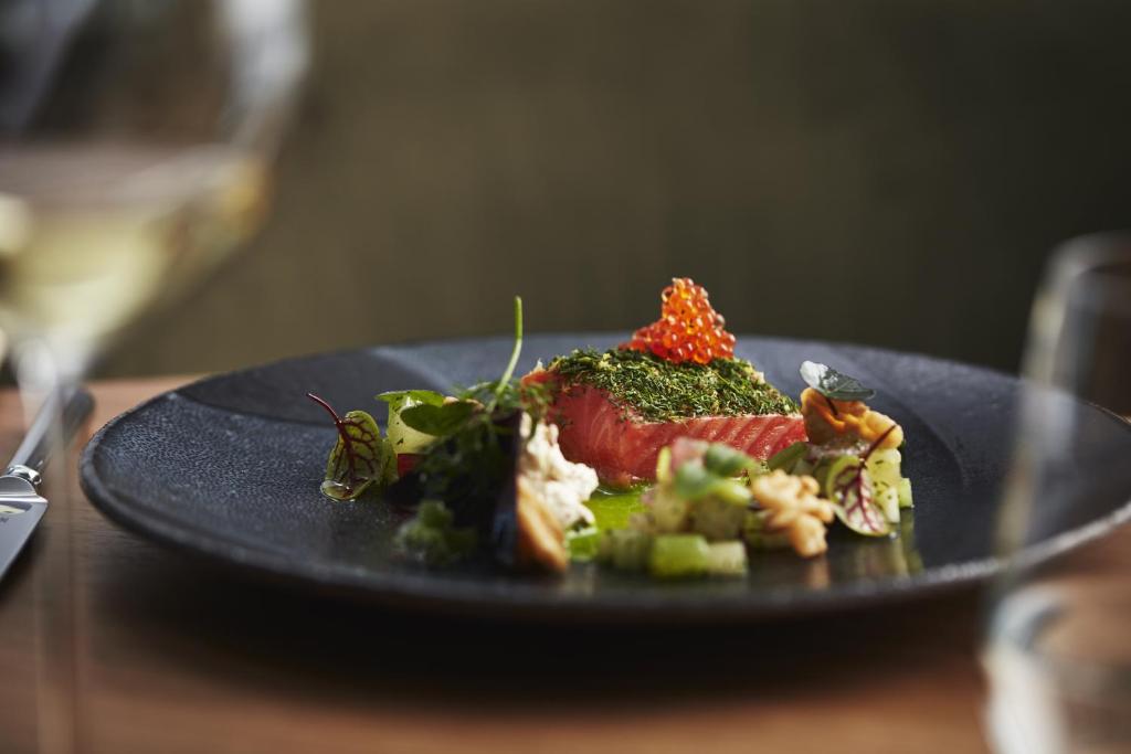 a black plate of food on a table at The Retreat at Blue Lagoon Iceland in Grindavík