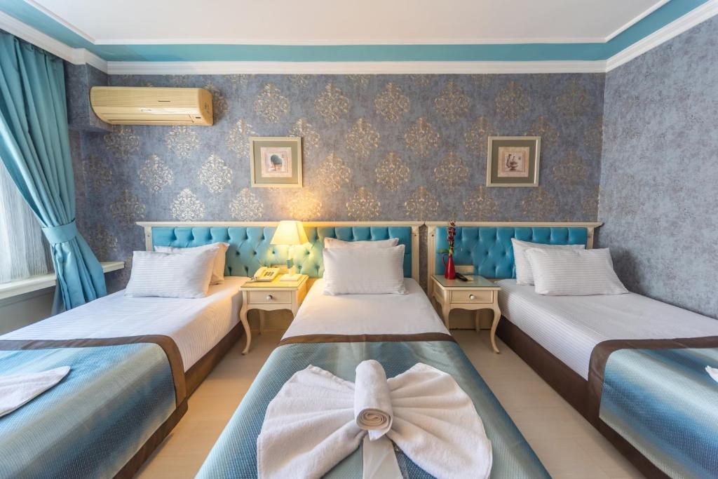 Postel nebo postele na pokoji v ubytování Viva Deluxe Hotel