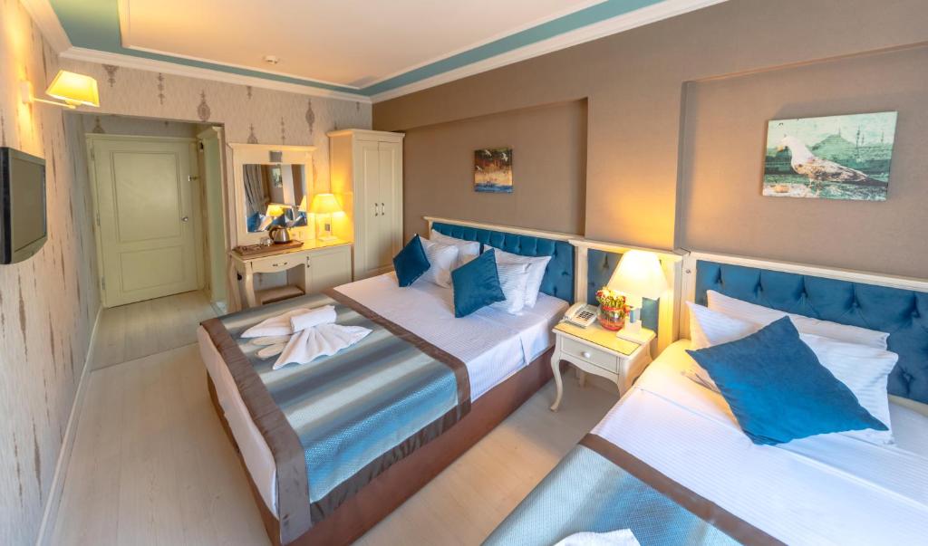 Postel nebo postele na pokoji v ubytování Viva Deluxe Hotel