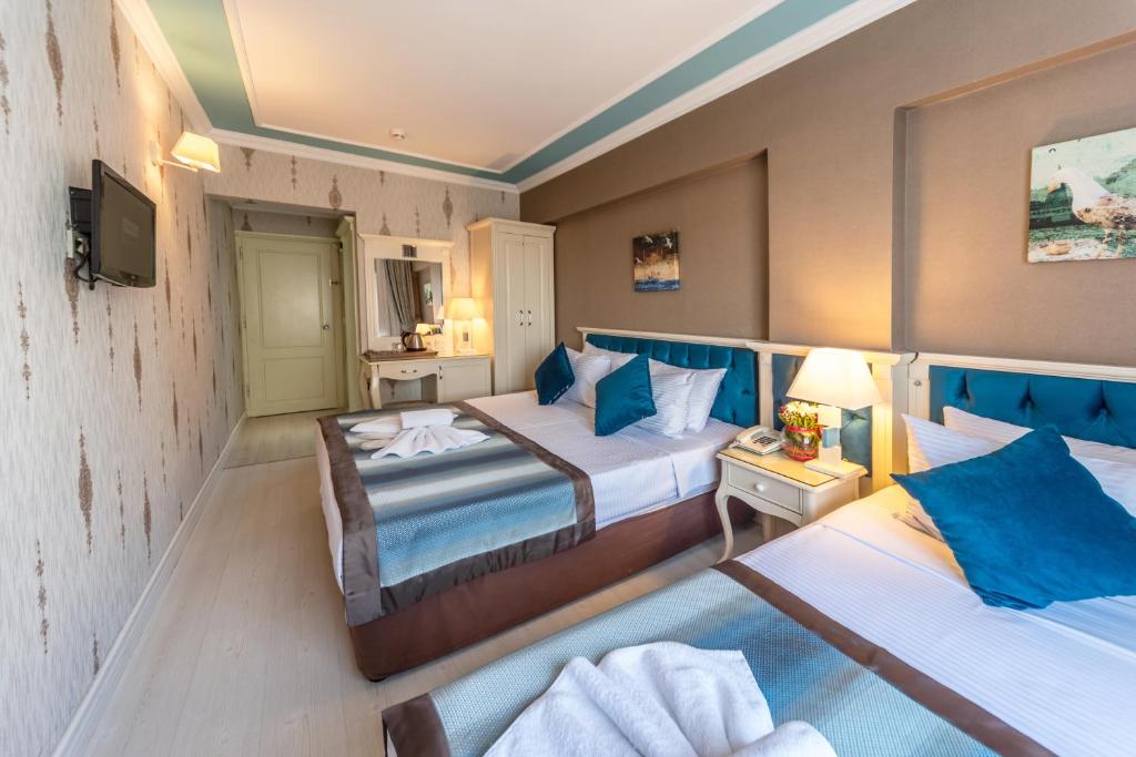 Postel nebo postele na pokoji v ubytování Viva Deluxe Hotel