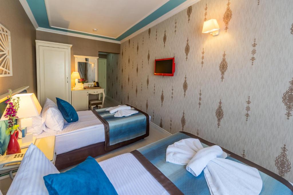 Postel nebo postele na pokoji v ubytování Viva Deluxe Hotel