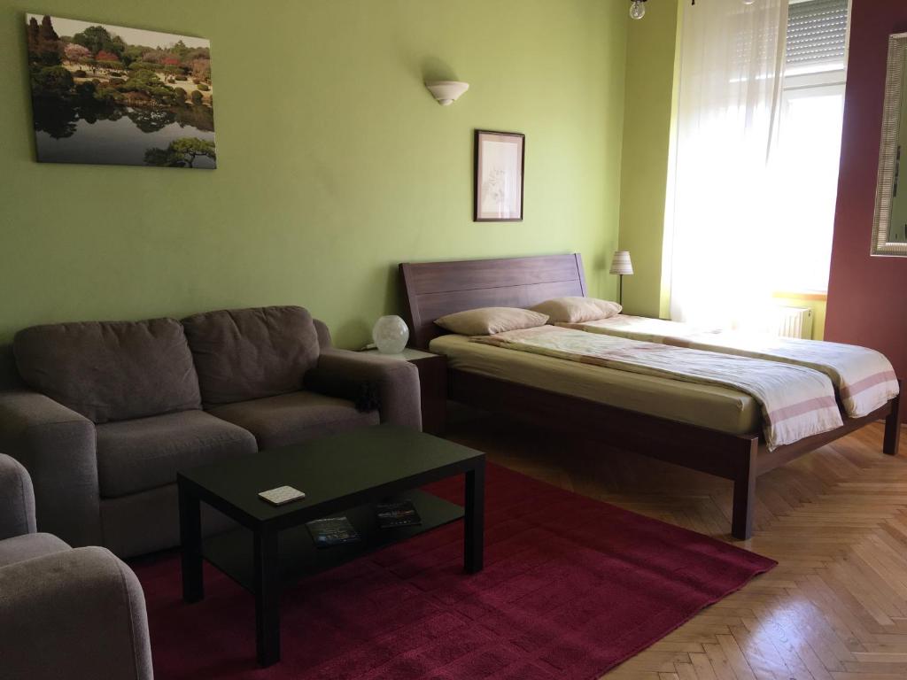 a living room with a bed and a couch at Studio along the Danube in Budapest