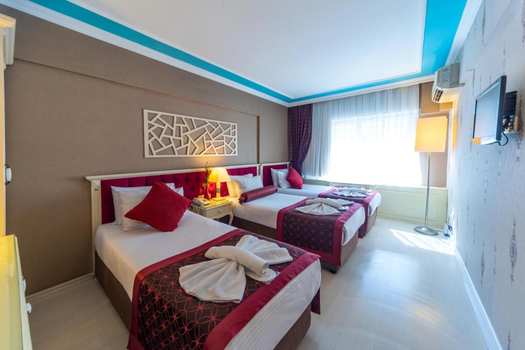Postel nebo postele na pokoji v ubytování Viva Deluxe Hotel