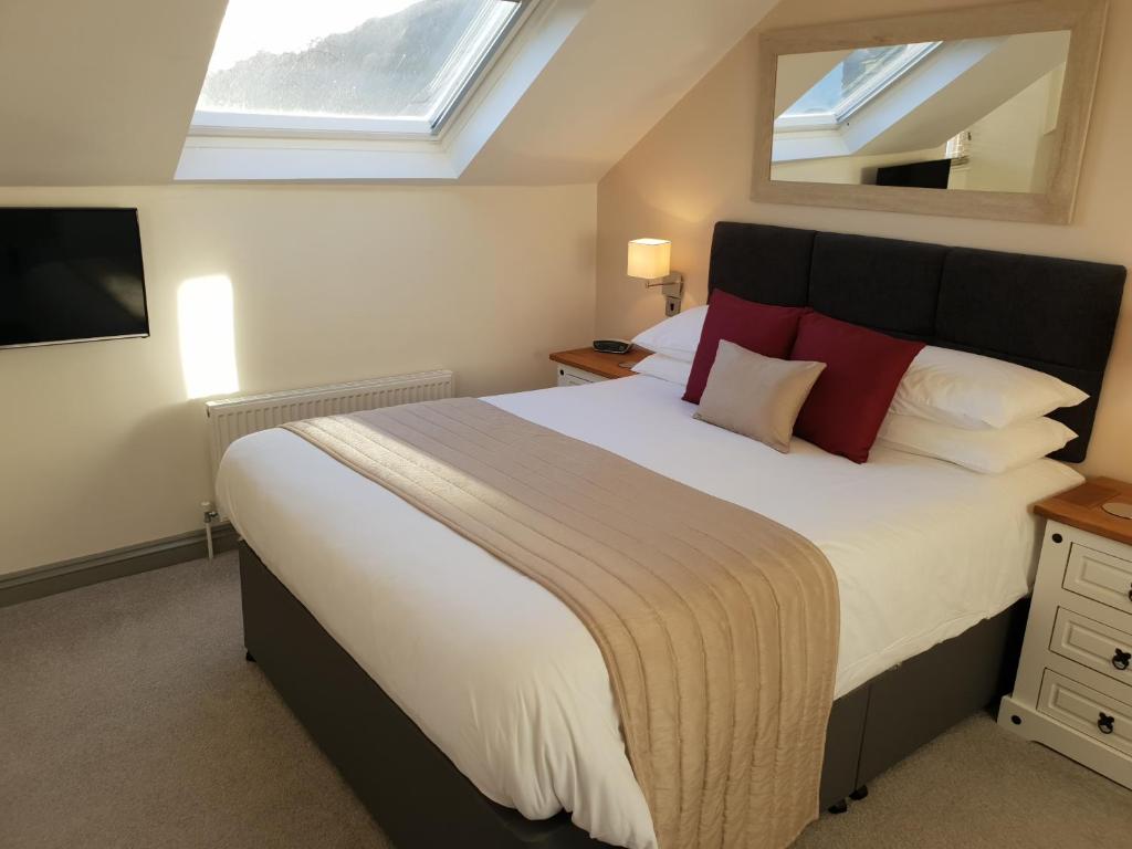 Un dormitorio con una cama grande y una ventana en Compston House B & B, en Ambleside