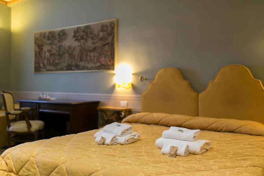 Postel nebo postele na pokoji v ubytování I Portici Hotel - Residenza D'Epoca