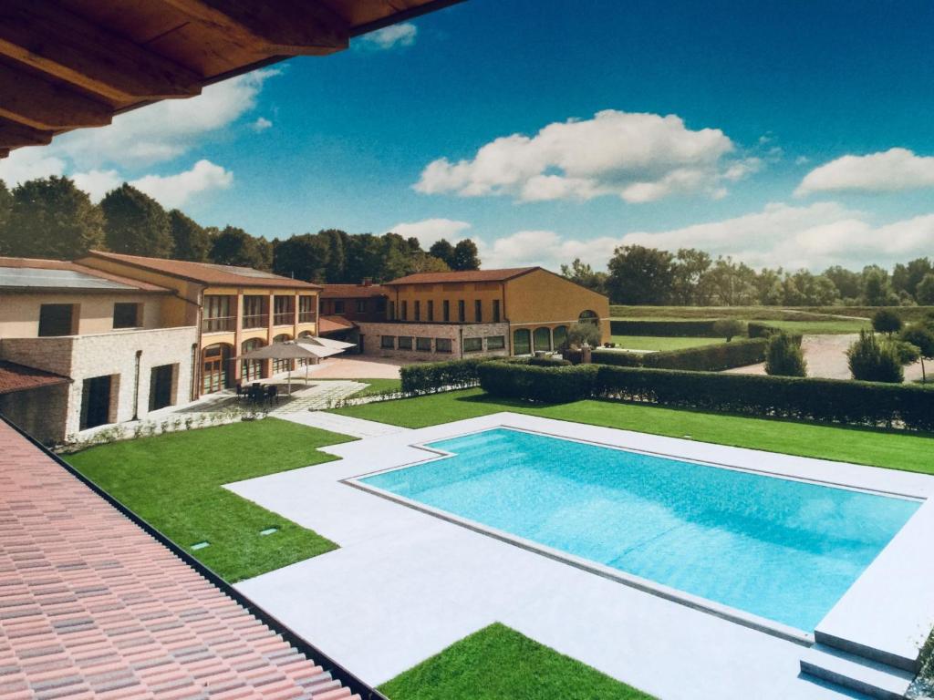 a swimming pool in the yard of a house at Tenuta Albertini in Zevio