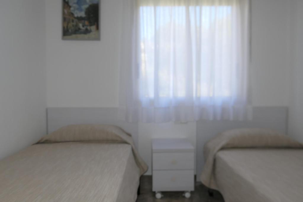 Postel nebo postele na pokoji v ubytování Cala Dorada Rentalmar