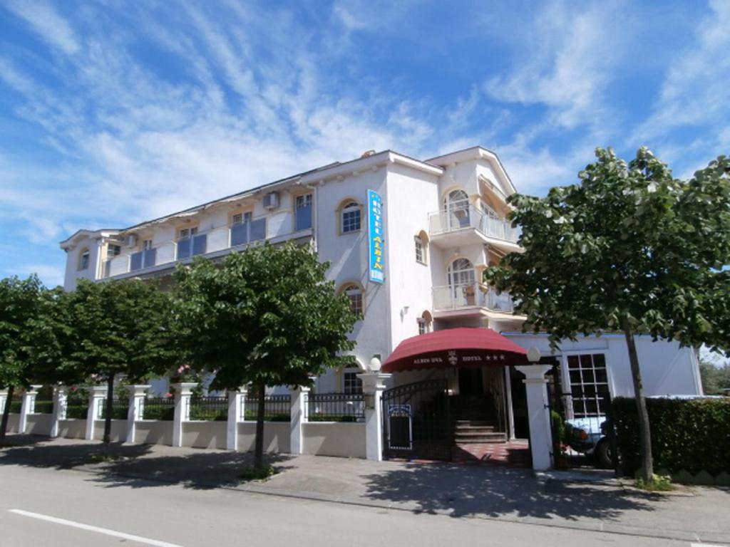 a white building with a blue sign on it at Avalena Rooms in Zadar