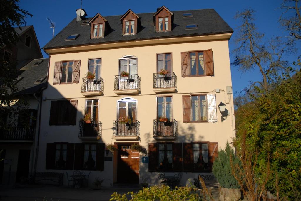 a white house with windows and balconies on it at Casa Es Neres in Les