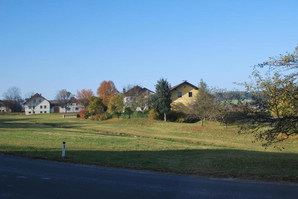 a house on a hill next to a road at Bauernhof Familie Tauber-Scheidl in Grossmeinharts
