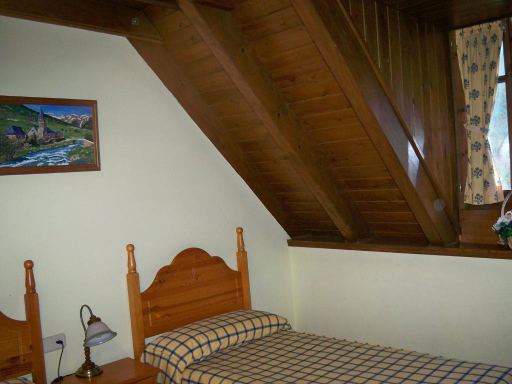 a bedroom with two beds and a wooden ceiling at Casa Es Neres in Les