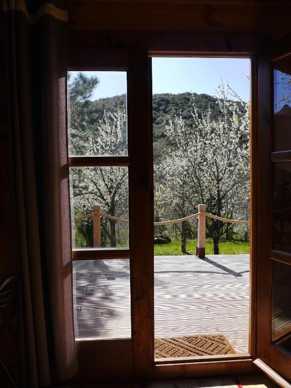 an open window with a view of a garden at Le Chalet in Prémian