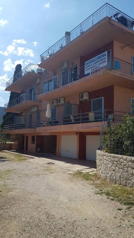 a large building with balconies and a sign on it at Athina Apartments Tolo in Tolo