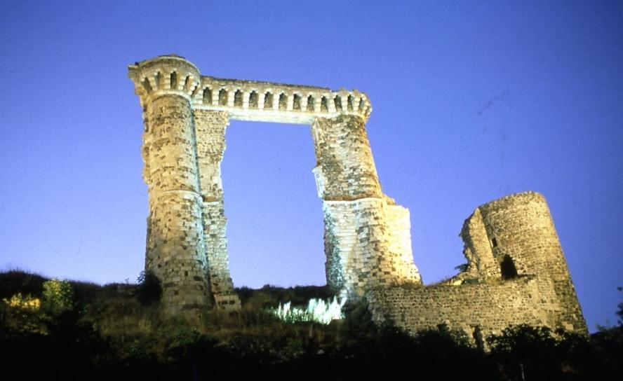 a stone building with an arch in the sky at Le Domaine De Fonteline in Allègre