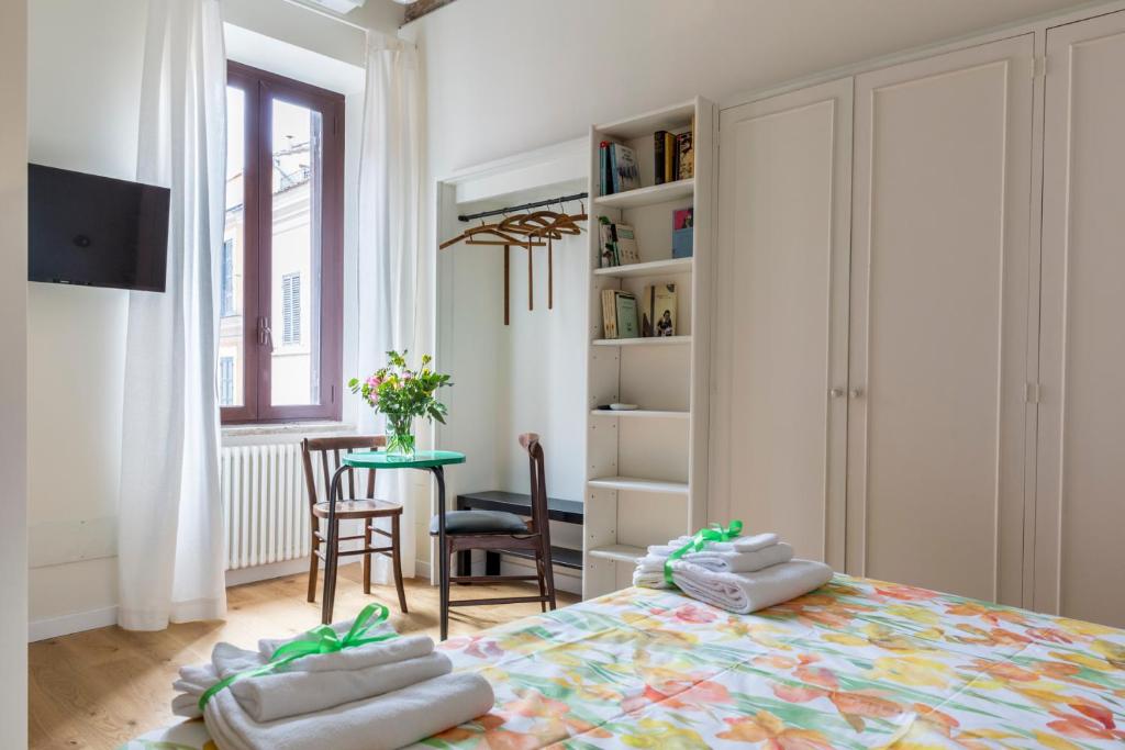 a room with a bed with two towels on it at Tolomeo Apartment in Rome