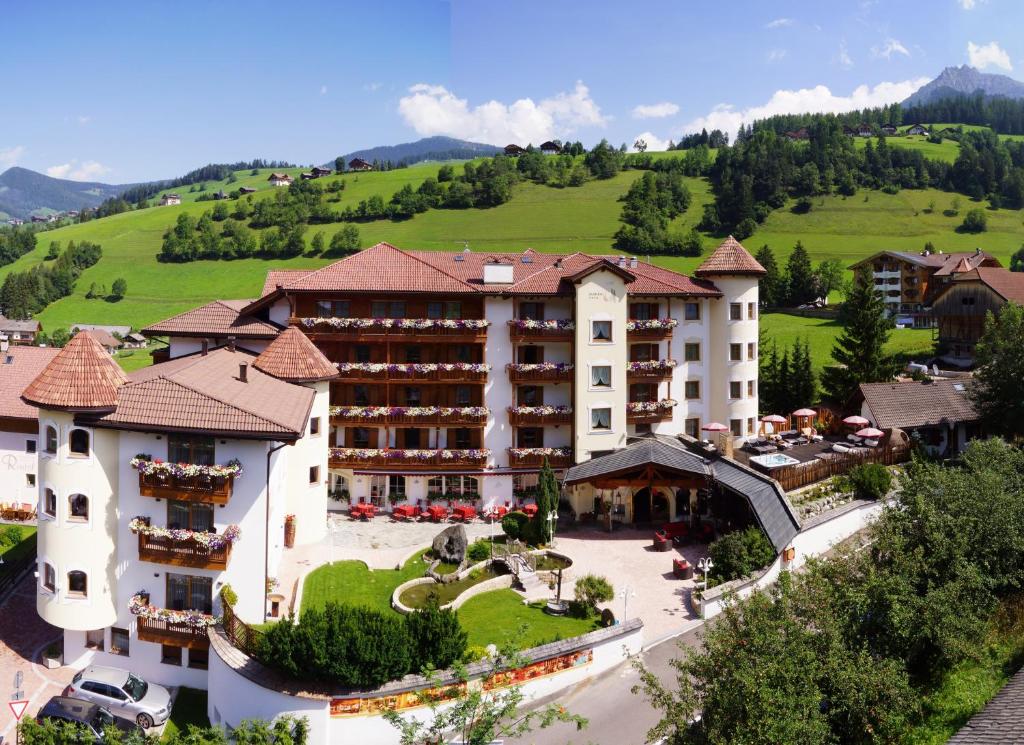 an aerial view of a hotel with mountains in the background at Almhof Hotel Call in San Vigilio Di Marebbe