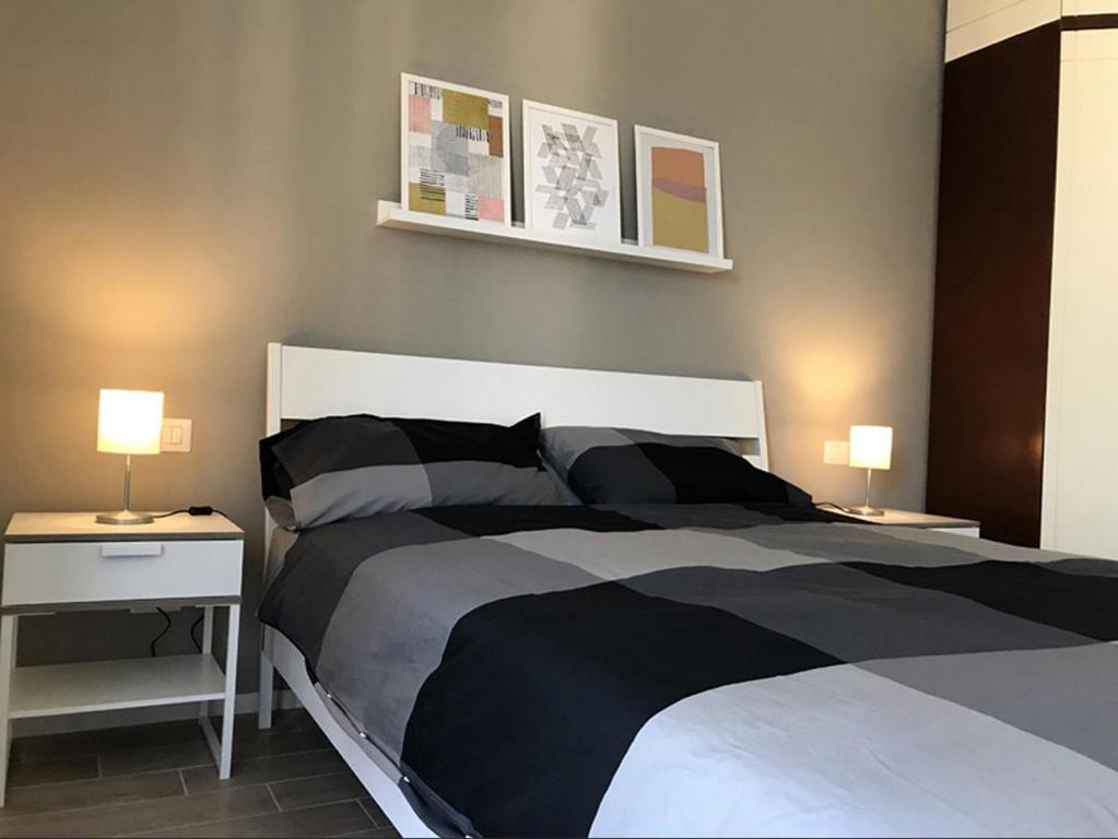 sypialnia z czarno-białym łóżkiem i 2 lampami w obiekcie Giuly'S House Cozy & Comfy Apartment in Rome ....Real Rome !!! w Rzymie