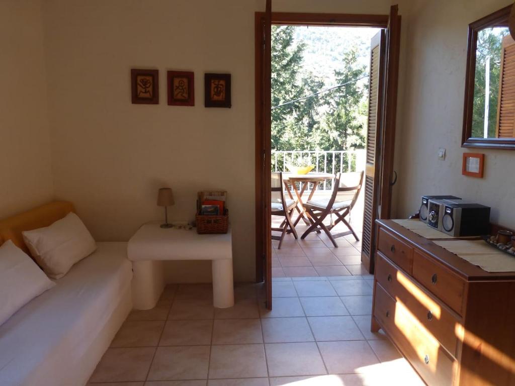 a living room with a bed and a couch and a table at Aperi View in Karpathos
