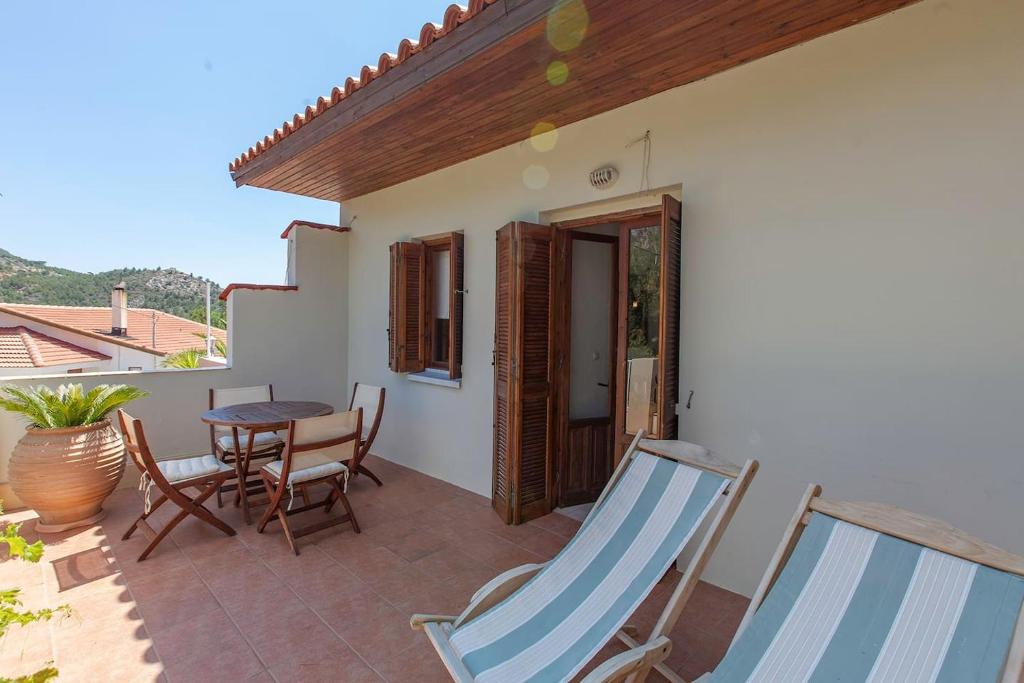 a patio with a table and chairs on a balcony at Aperi View in Karpathos