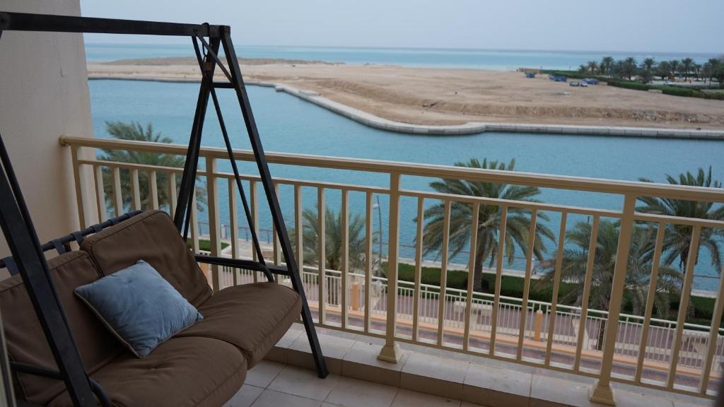 a couch on a balcony with a view of the beach at marina two apartment 201 with direct sea view in King Abdullah Economic City
