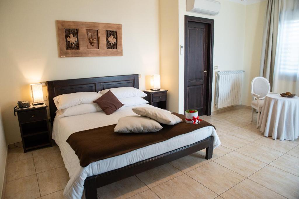 a bedroom with a bed with two pillows on it at Bellavigna Country House in Montefalcione