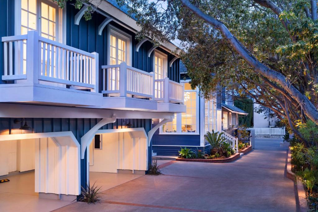 a blue building with a balcony on a street at Hideaway Santa Barbara, A Kirkwood Collection Hotel in Santa Barbara