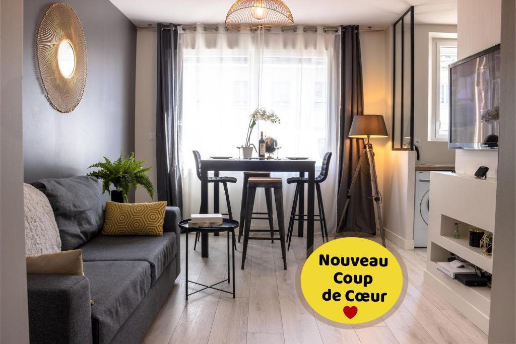 a living room with a couch and a table at appartement le carnel in Lorient