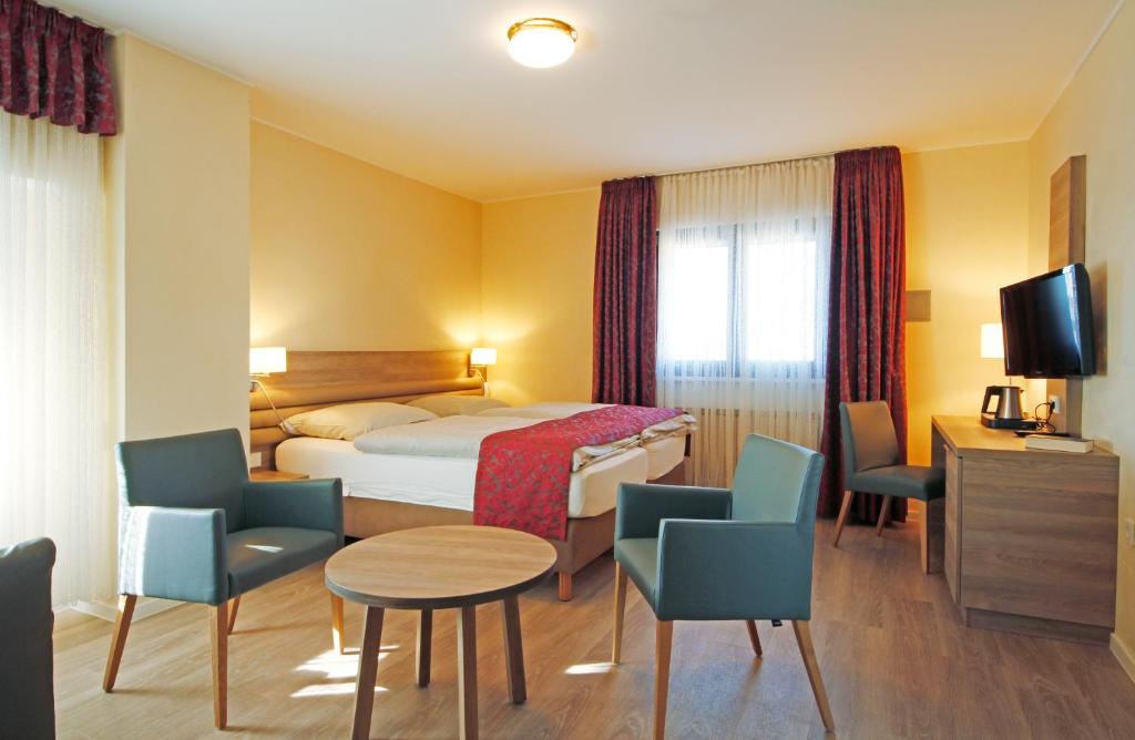 Postel nebo postele na pokoji v ubytování Hotel Saint Fiacre
