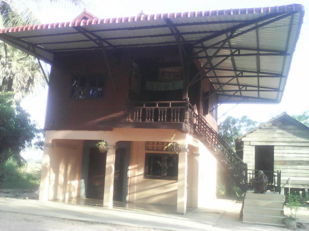 a building with a staircase on the side of it at Chansor Community Homestay 11 in Siem Reap