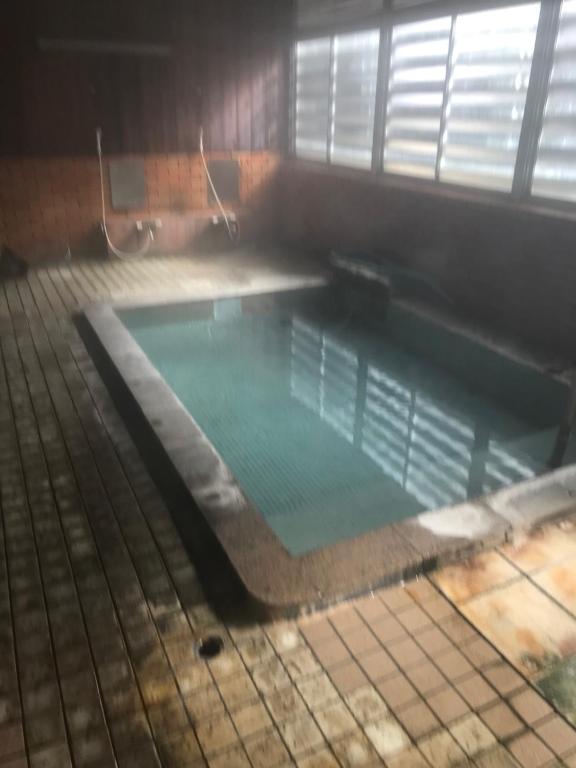 a large swimming pool in a building at Yamatoya in Nozawa Onsen