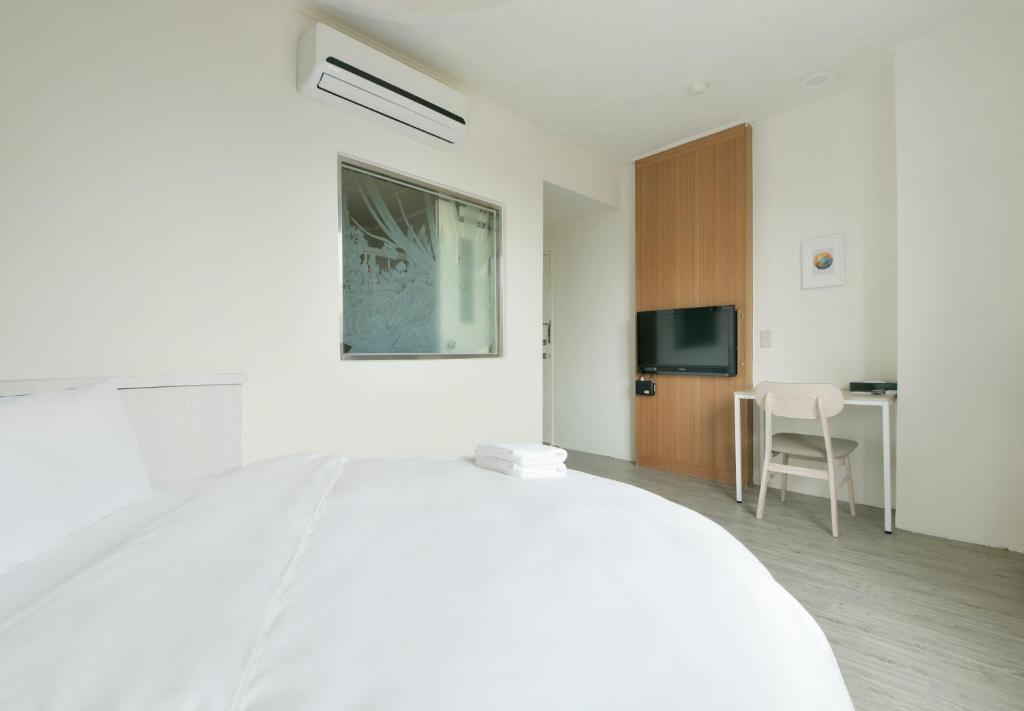 Postel nebo postele na pokoji v ubytování Raise Hotel Taichung