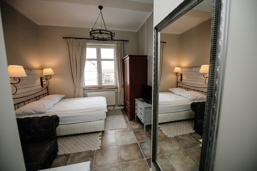 Postel nebo postele na pokoji v ubytování Apartamenty Kuźnia