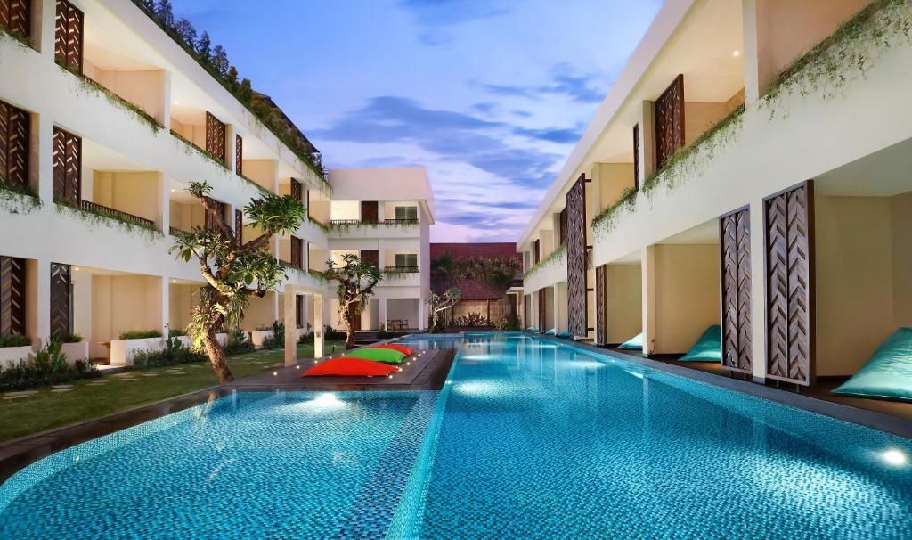 a swimming pool in the middle of a building at Anja Jimbaran in Jimbaran